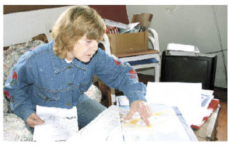 North Whidbey resident Becky Spraitzer examines documents concerning an accident potential zone she wants remanded.