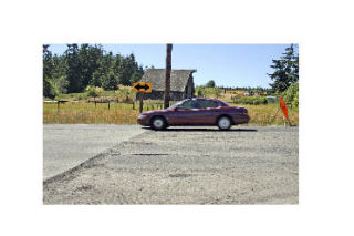 A car goes over an ugly bump on Highway 20 Wednesday afternoon. Several drivers complained about it and the state responded.