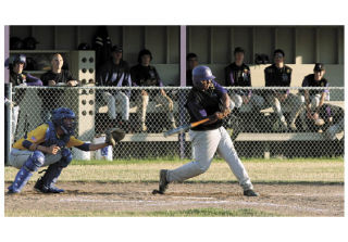 Oak Harbor’s Kian Mebane has the pitch perfectly timed and lifts a sacrifice fly to left  field. Mebane had two hits