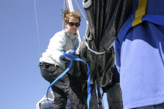 Catherine Slawson helps raise the mast of  the Opposition before the crew positions themselves for their Race Week heat Thursday. Opposition finished in eighth-place in the P6 class.