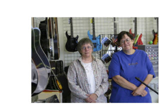 Owner Avi Rostov and manager Sheila Rhyne hang out in Clickmusic.biz’s guitar department.