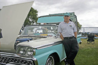 Bellingham resident Jack Bittner stands next to his 1959 Ford Skyliner hardtop convertible at the North Whidbey Lions Club Car Show last weekend.