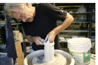 Pottery artist Dan Ishler demonstrates his technique with the potter’s wheel with clay from Laguna Beach.