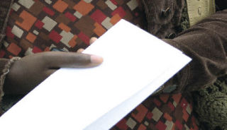 The mother of abuse victims holds a written statement read at a press conference.