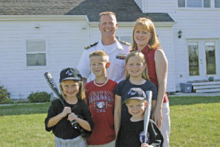 The family assembles in the backyard before a quick game of baseball