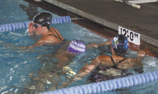 Members  of the Oak Harbor swim team take a quick break at the deep end of John Vanderzicht Memorial Pool during an afternoon practice session. The Wildcats return anumber of talented swimmers in 2008 and should challenge for the WesCo League championship.