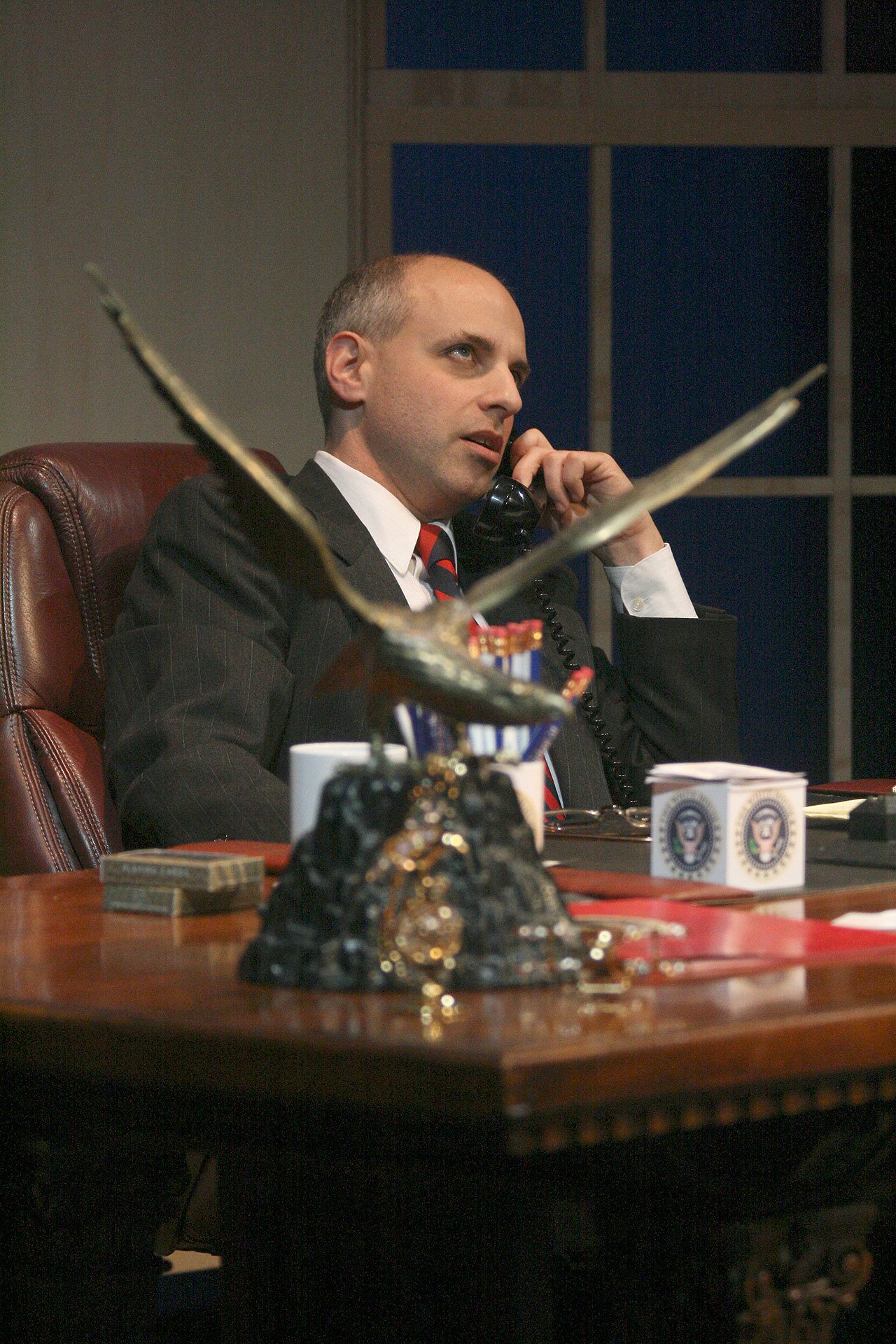 President Charles Smith rolls his eyes as he argues with one of his colleagues on the phone.