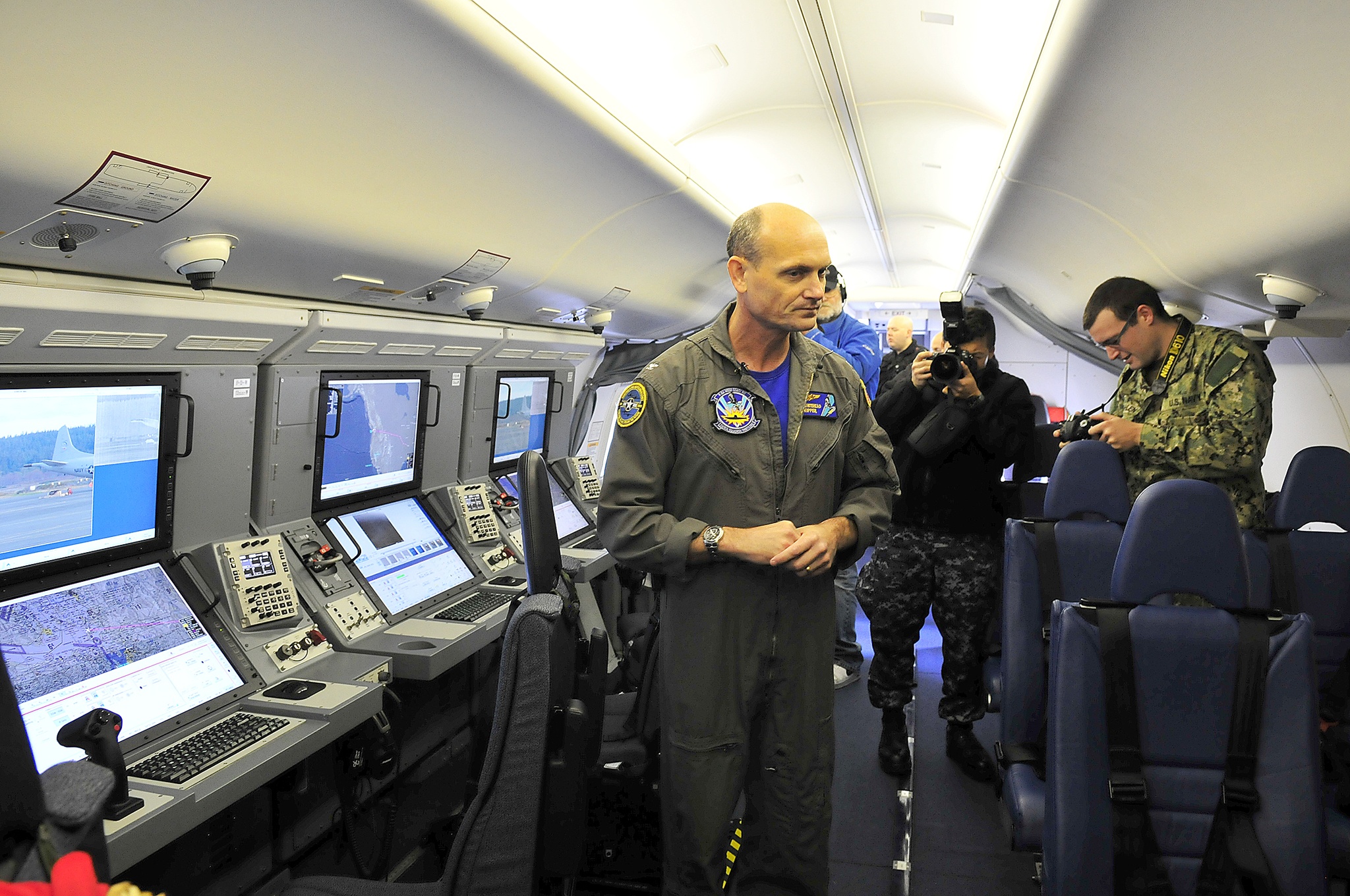 Capt. Dave Whitehead, commanding officer, Patrol Squadron 30, gives media a tour inside the squadron’s first P-8 Poseidon aircraft at Naval Air Station Whidbey Island Friday.