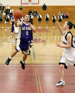 Cheyenne Tubo drives the lane and scores on a scoop shot.