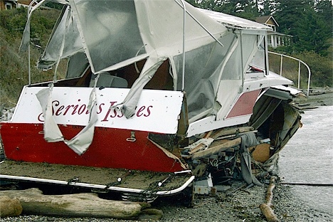 A small boat dubbed “Serious Issues” breaks up near the driftwood on the north edge of Penn Cove Monday.