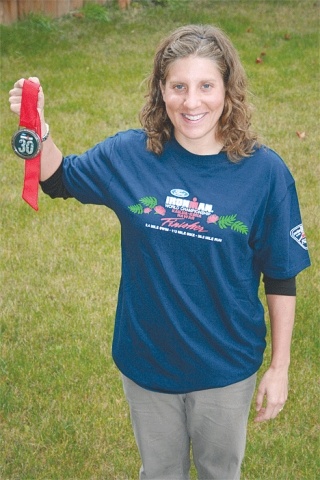 Sara McGrath holds her finisher’s medal from the Kona Ironman race. McGrath completed the 2.4 mile swim