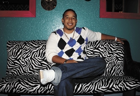 Seven West owner Darnell Allen lounges on a zebra-striped couch in the back room/dance area of the club