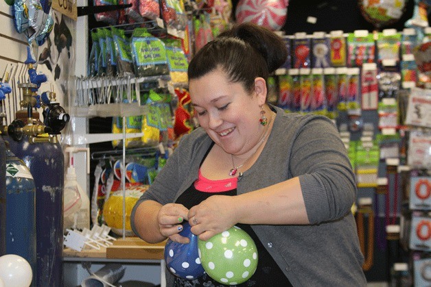 Connie Arroyos of Whidbey Party Store hurries to prepare a Seahawks balloon bouquet Jan. 29 in Oak Harbor.
