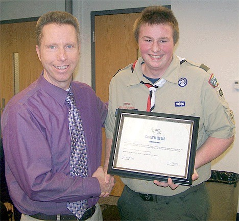 Island County Children’s Commission member Rod Merrill presents Zach McCormick with the “Caught in the Act” award.
