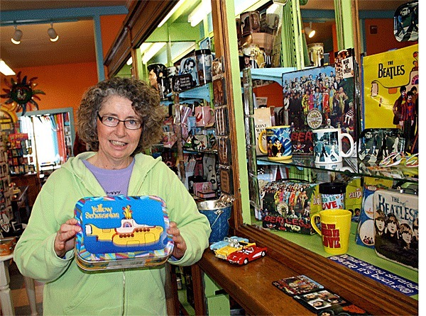 Far From Normal owner Cindy Van Dyk diplays a Yellow Submarine lunchbox