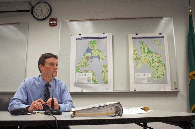 Island County Planning Director David Wechner field’s questions about marijuana-related land use standards from the planning commission and residents at Tuesday’s regular meeting. On display at the meeting are the county’s zoning maps.