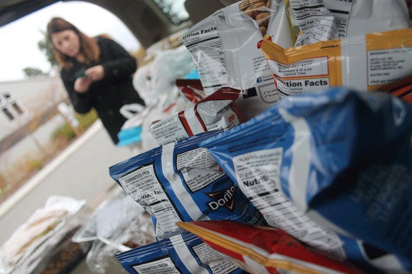 Food piles up fast in a volunteer’s car Saturday for the memorial service.
