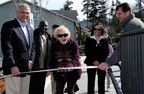 Oak Harbor Parks Board member Helen Chatfield-Weeks performed the honors of cutting the ribbon while Mayor Jim Slowik and Hank Nydam