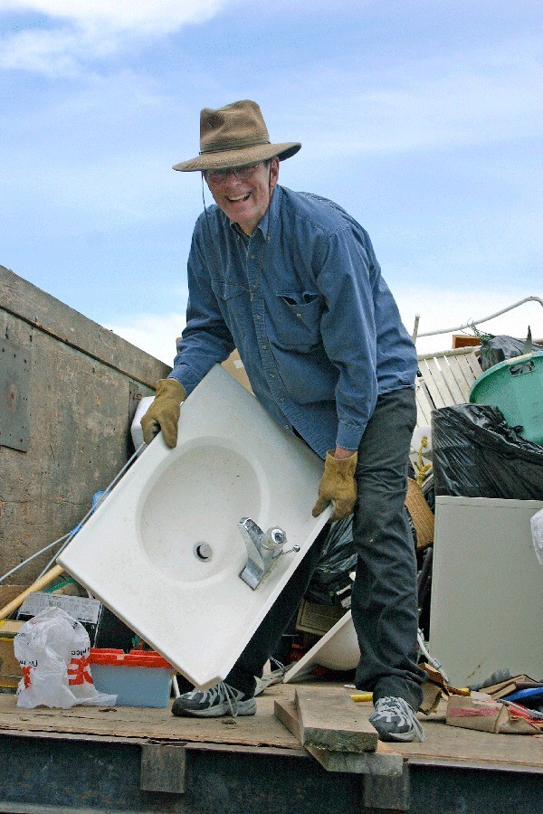 Coupeville Lions Club volunteer Ed Walker unloads a sink from a truck. The hugely popular Coupeville Lions Club Garage Sale takes place Fourth of July weekend.