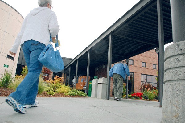 Two people head toward the front entrance of Whidbey General Hospital
