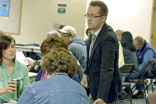 Oak Harbor High School choir director Darren McCoy talks about the levy with the crowd during a workshop about how the taxpayer funds help athletics and activities in the district.