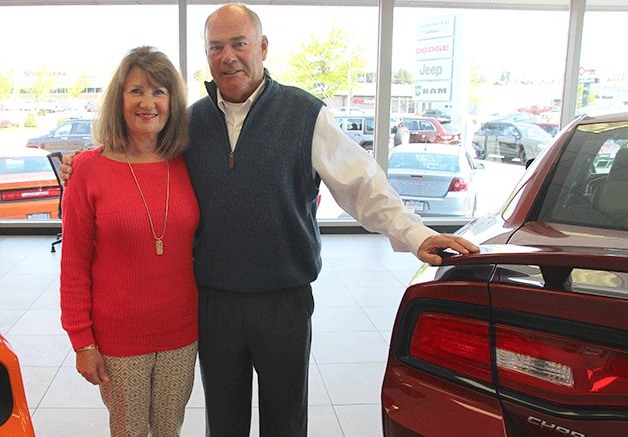 Mike and Cathy Horrobin stand in the showroom of Oak Harbor Motors. They will be celebrating their 35th year in business this August.