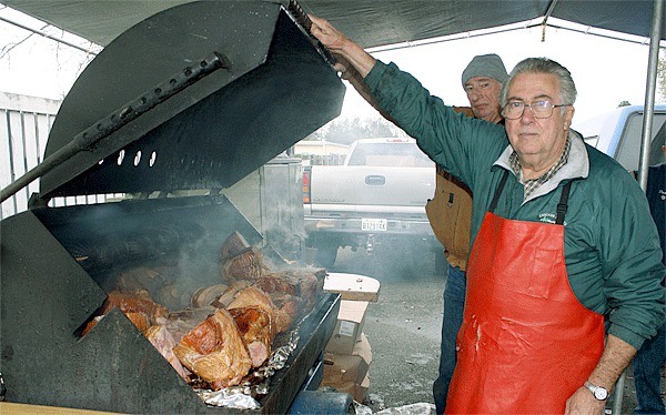 Volunteer Roger Anglum displays some of the 600 pounds of ham cooked for the North Whidbey Community Harvest