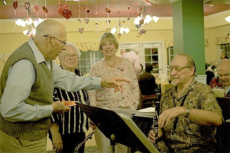 Valentine’s Dinner attendees take a moment to talk with a member of the Jerry Jones Whidbey Jazz Band.