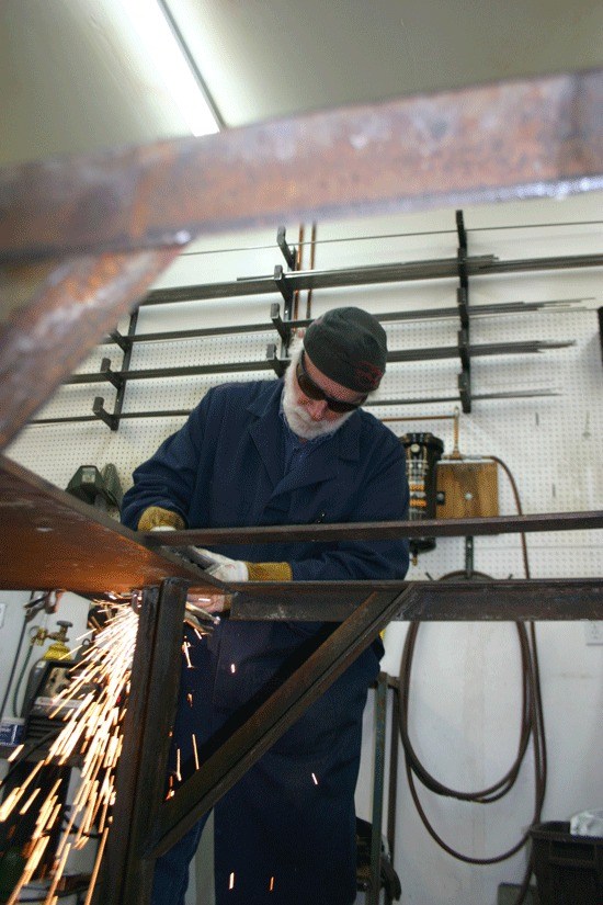 Steve Nowicki cuts metal using a plasma cutter at his Oak Harbor studio