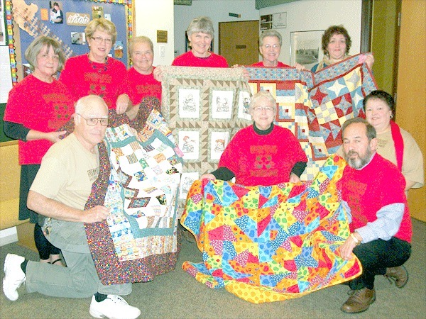 The 2010 Watoto Team shows off the four quilts they’re raffling off to help raise money for additional supplies at the new medical center in Gulu