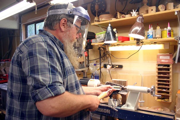 Chris Oatley works on a project in his workshop. The Navy veteran said he finds woodworking soothing.