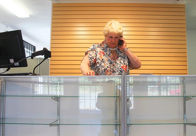 Whidbey Island Cannibis Co. owner Maureen Cook stands behind empty display shelves. Not only wasn’t there product to sell