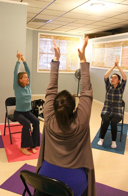 Demonstrating yoga exercises led by Renee Le Verrier are Laurie Gonzalez