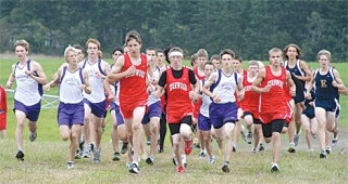 Runners charge up the first of  many hills at the Wirth Farm at the start of  Thursday’s boys cross country  race. Oak Harbor’s Tyler King
