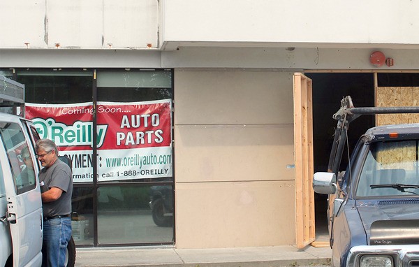 An O’Reilly Auto Parts banner hangs in the window of the former Blockbuster building. O’Reilly is slated to move into the building later this year.