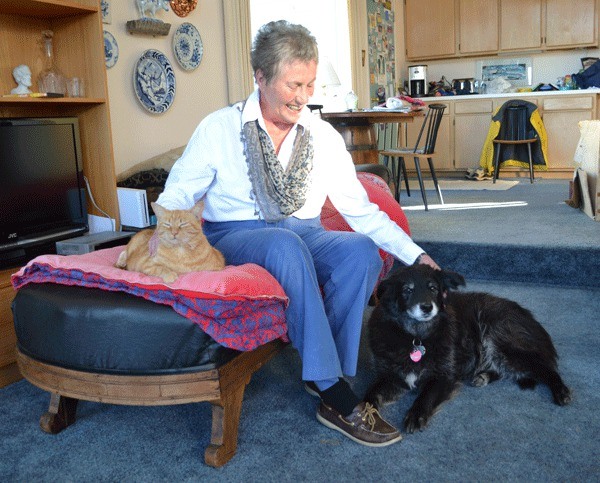 Barb Bland sits with her cat Mazie and her dog Belle at her home in Oak Harbor.