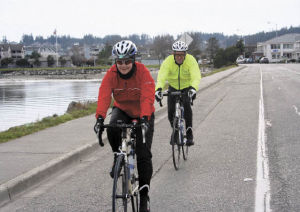 Missy Merickel and Jim Somers cycle down Bayshore Drive Thursday afternoon behind