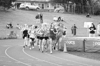 Oak Harbor’s Mietra Smollack leads the pack into the home stretch on the first lap of the 1