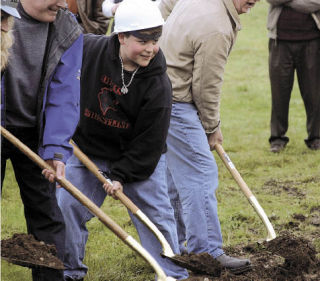 Student Devere Dudley of Oak Harbor Middle School digs into the site of Oak Harbor High School’s new wing