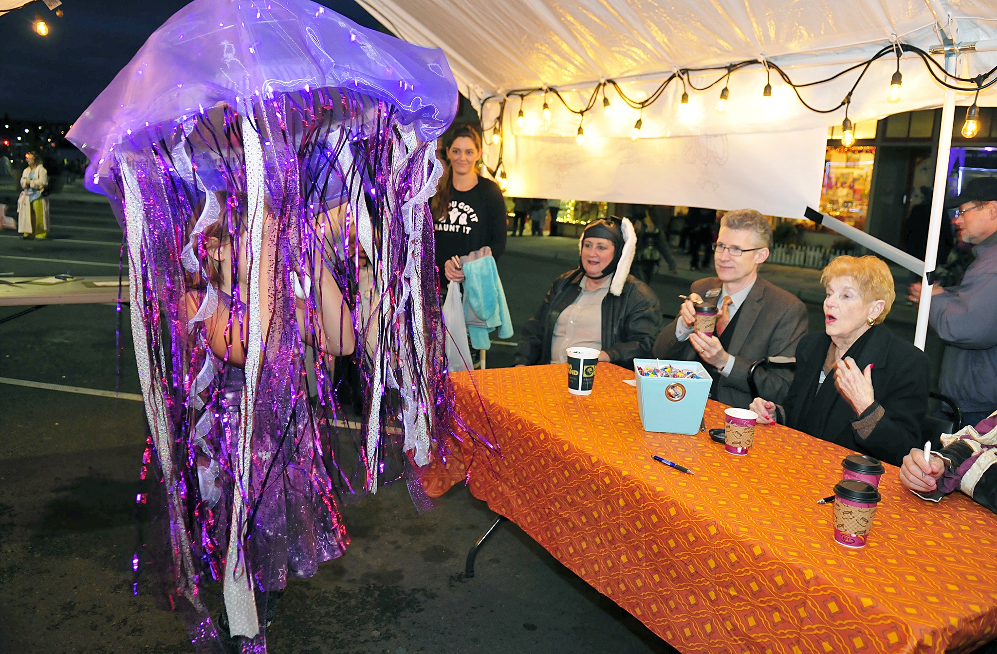 Nisa Hagan, left, shows off her jellyfish costume to judges Lance Gibbon, Oak Harbor Public School superintendent and Sandra Mulkey, director at Regency on Whidbey Monday on Pioneer Way in Oak Harbor. Photo by Michael Watkins/Whidbey News-Times