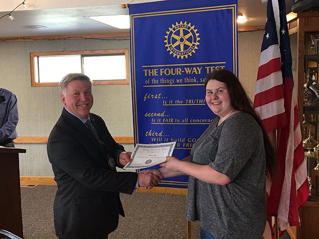 Student of the Month Patricia Hill accepts her certificate from Rotary President Greg Smith.