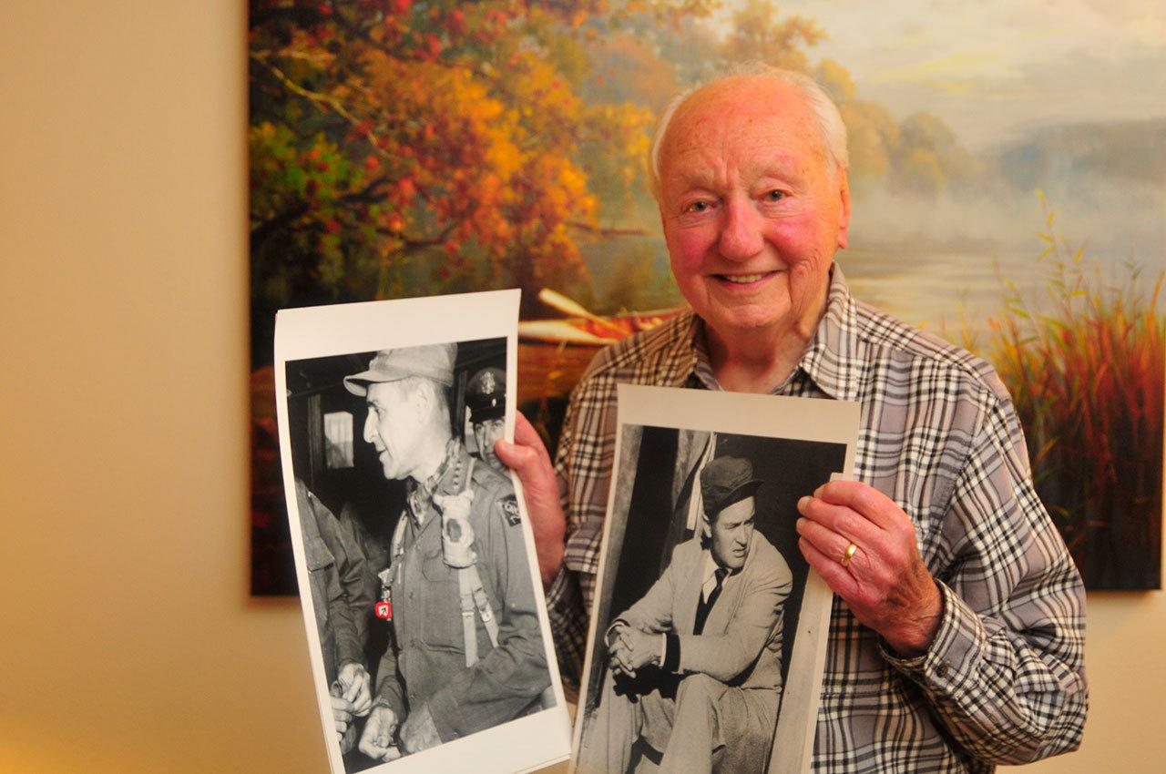 Michael Russo proudly hold two of his photographs he took over his career. On the left is a photo of General Matthew Ridgway and right, a photo of comedian Bob Hope. Photo by Michael Watkins/Whidbey News-Times