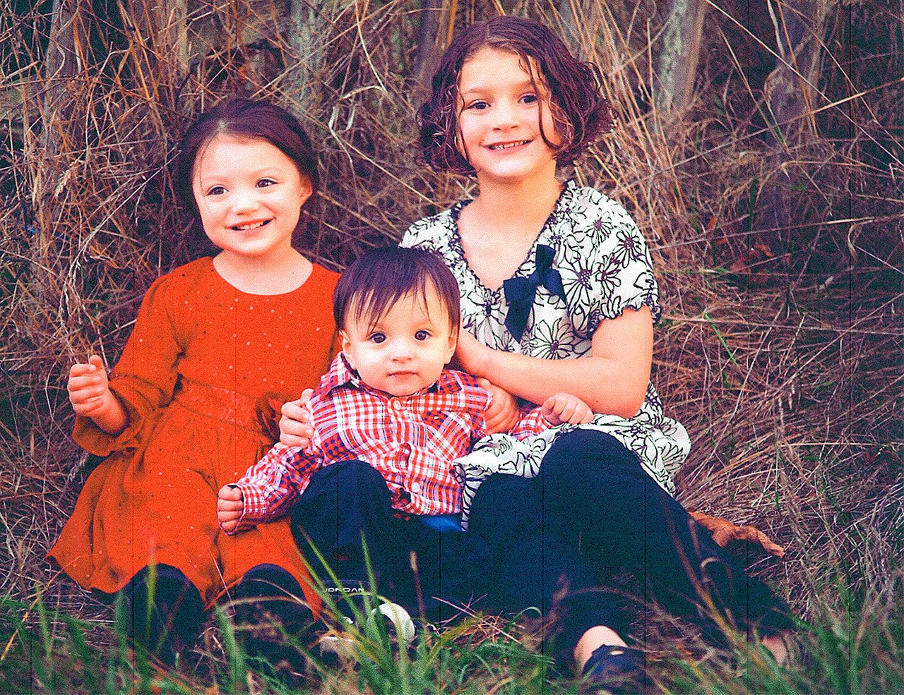 Ethan Edwards, center, is surrounded by his sisters Mia, left, and Alexis, in a photo taken in October. Photo provided