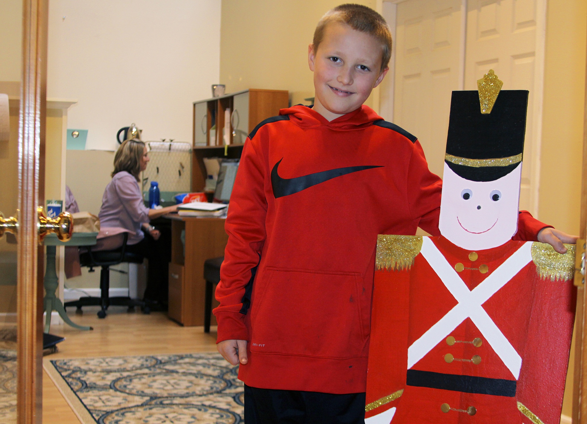 Ethan Riker, 9, gets better acquainted with a toy soldier that welcomes guests to the Oak Harbor Main Street office on Pioneer Way in Oak Harbor. The organization placed 34 of the soldiers up for adoption, asking community members and businesses to decorate them for public display downtown later this month. This one was painted by Whidbey Island artist Margaret Livermore. Photo by Ron Newberry/Whidbey News-Times