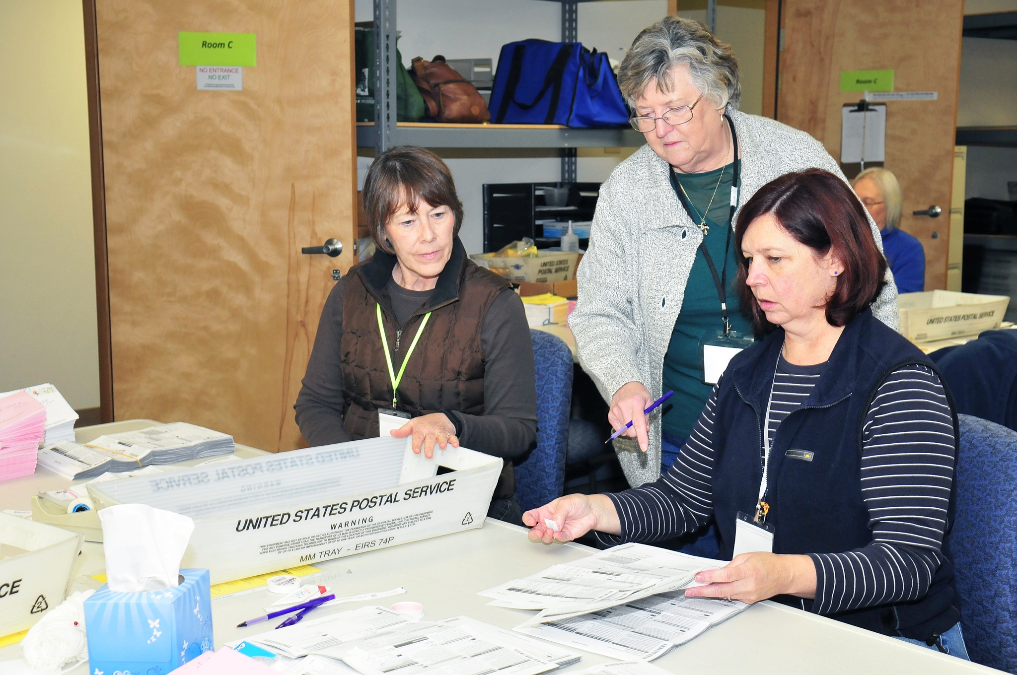 From left to right, Casie Horr, Maggie Paczaowski and and Toni Craggs process ballots in Coupeville Monday.