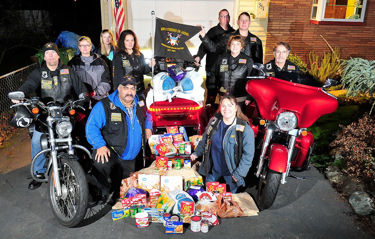 The Brothers in Arms Motorcycle Club prepares to donate complete holiday meals and gift cards to those less fortunate. Photo by Michael Watkins/Whideby News-Times