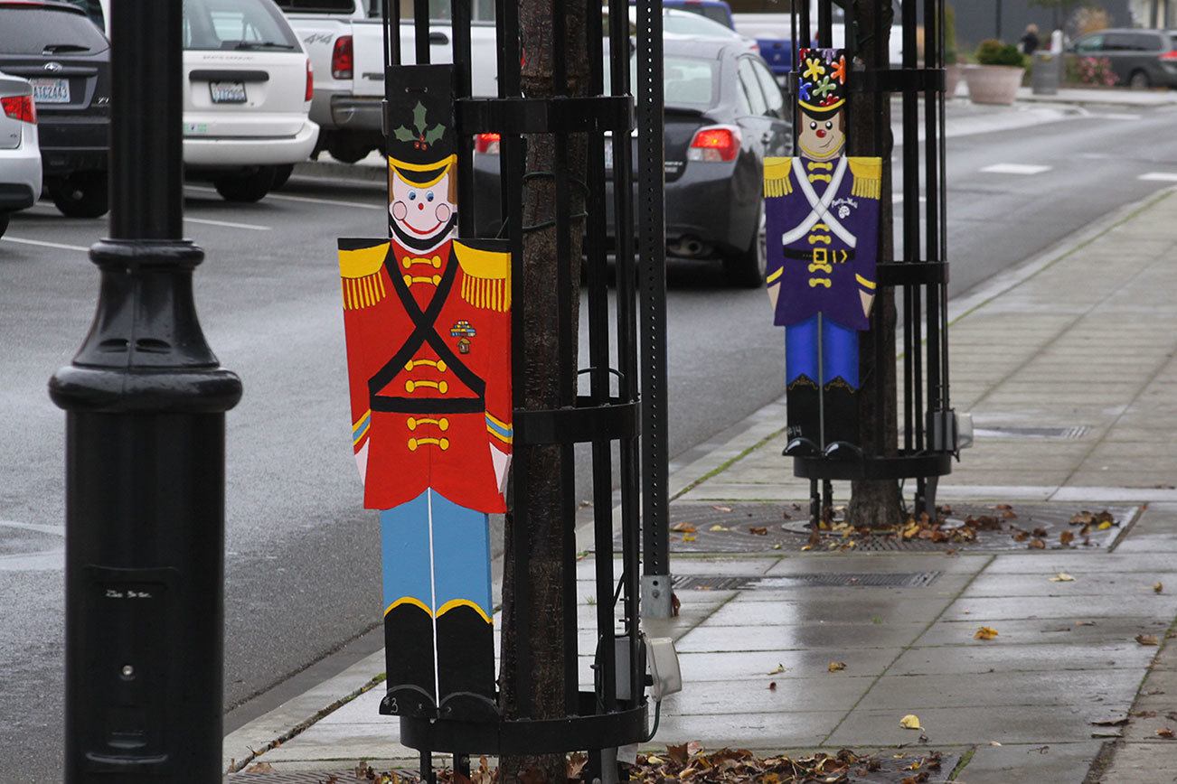 Toy soldiers line Pioneer Way in Oak Harbor last week. The Oak Harbor Main Street Association came up with the idea for the community to “adopt a soldier,” and decorate them for public display. Four were stolen and another four vandalized over the weekend. Photo by Ron Newberry/Whidbey News-Times