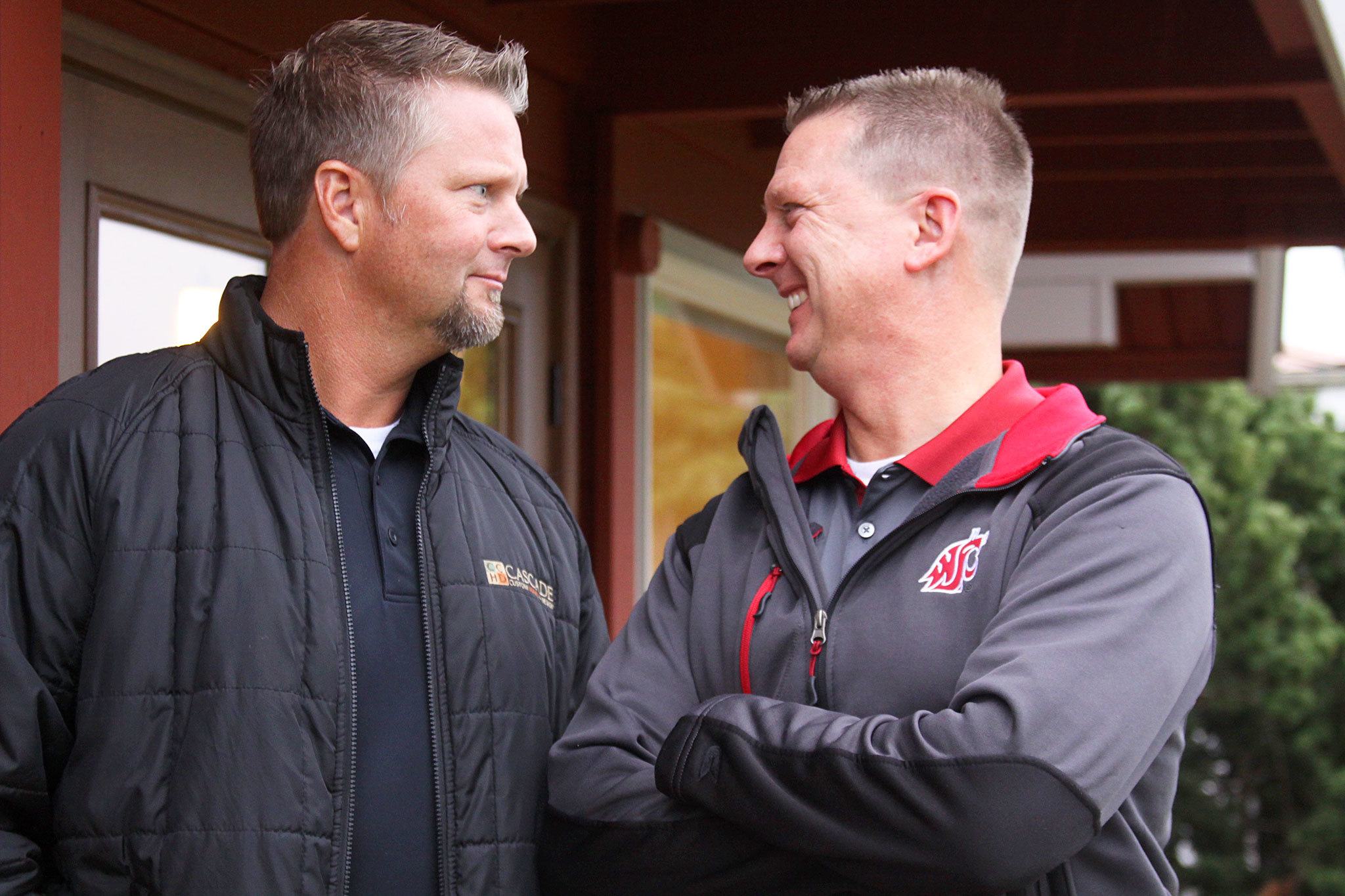 Brothers Jay and Jon Roberts of Coupeville own a custom home building design business together but don’t share the same allegiance when it comes to the Apple Cup. Jay is a longtime Huskies season-ticket holder while Jon is a Cougars alum and diehard fan. Photo by Ron Newberry/Whidbey News-Times