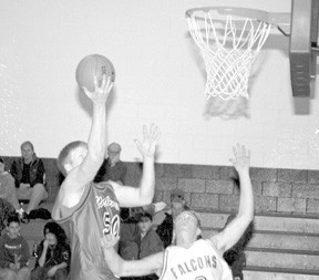 Coupeville’s Chris Good rises for a shot attempt in the first half of the Wolves’ 61-52 loss to the South Whidbey Falcons in the opening game of the 2001 South Whidbey Holiday Classic. Good led all scorers with 23 points on the night.