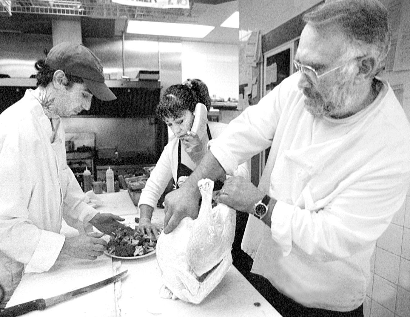Pot Belly Deli manager Carol Crale takes a phone order while owner Keith Bartlett